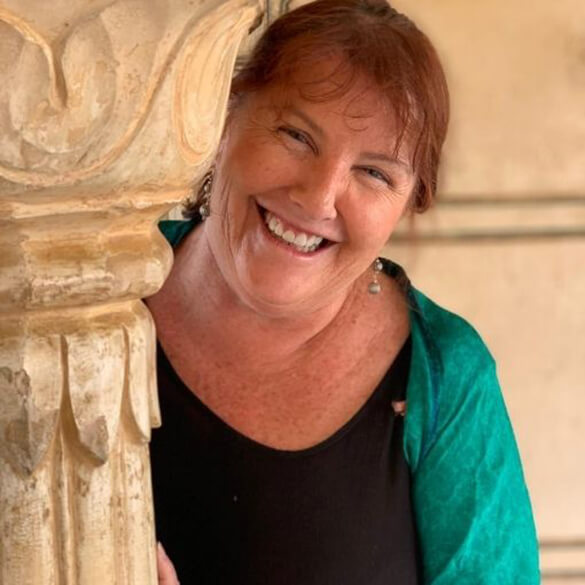 lady holding marble pillar and smiling