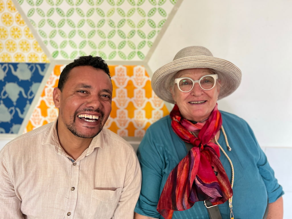 two people smiling at the camera having a good time