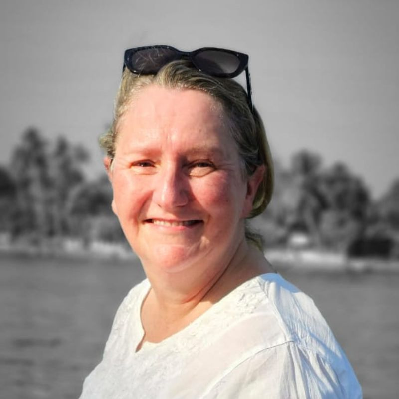 lady wearing white shirt with lake in background