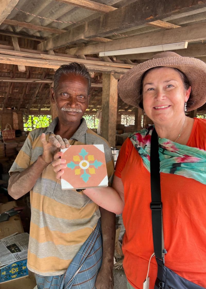 Indian man and tourist tolding handmade tile